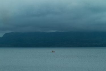 Isolation vs. loneliness boat in body of water